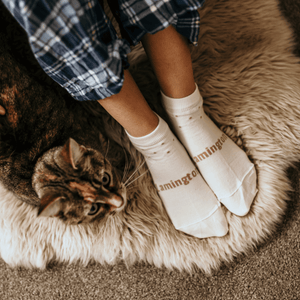 woman wearing merino wool ankle socks cream and purple spots nz