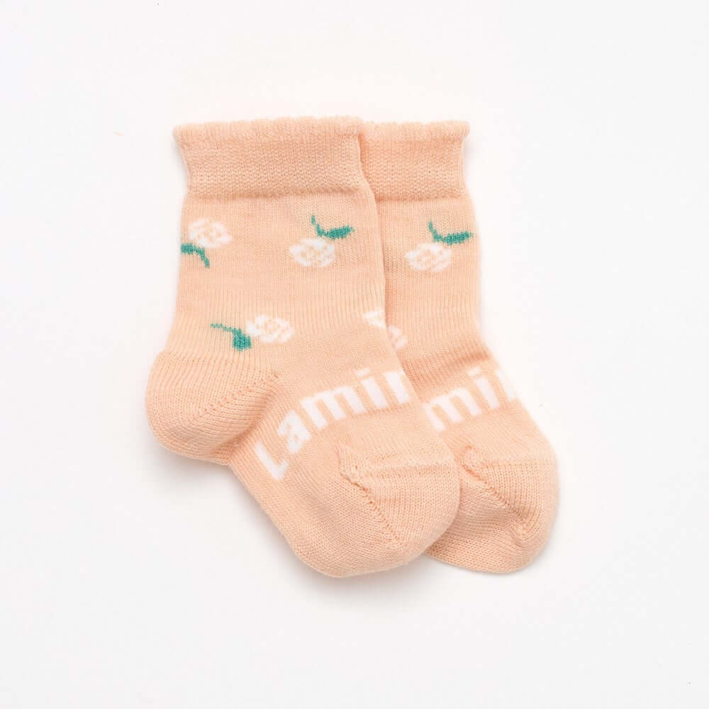 Peach with floral design and a cute frill top merino wool socks for babies 